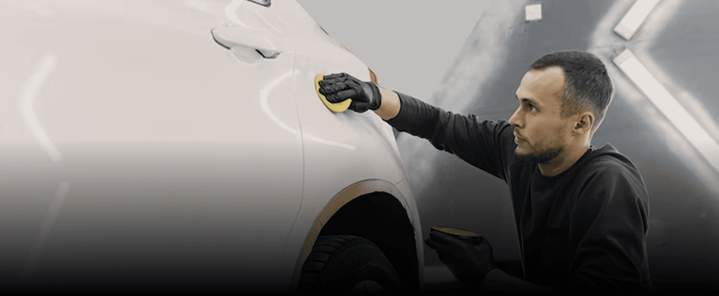 Professional detailer working on a car